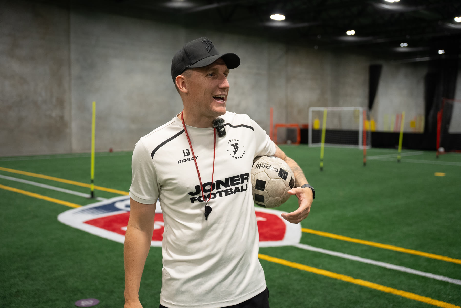 Lee Jones holding a ball at a Joner Football session